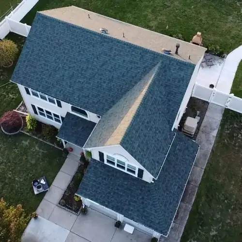 Blue shingle roof on a two-story home, seen from above
