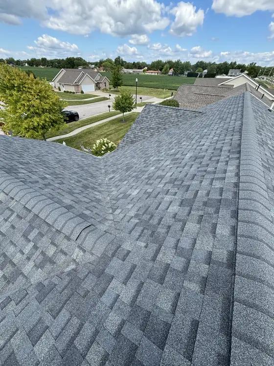 Close-up of fresh architectural shingles along a ridge